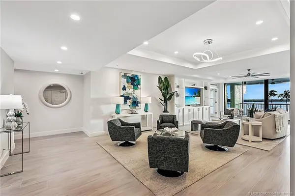 a living room with furniture and a wooden floor