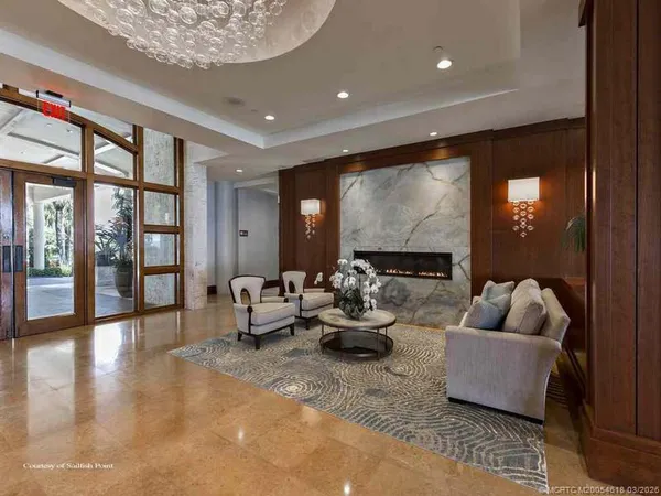a living room with furniture and large windows