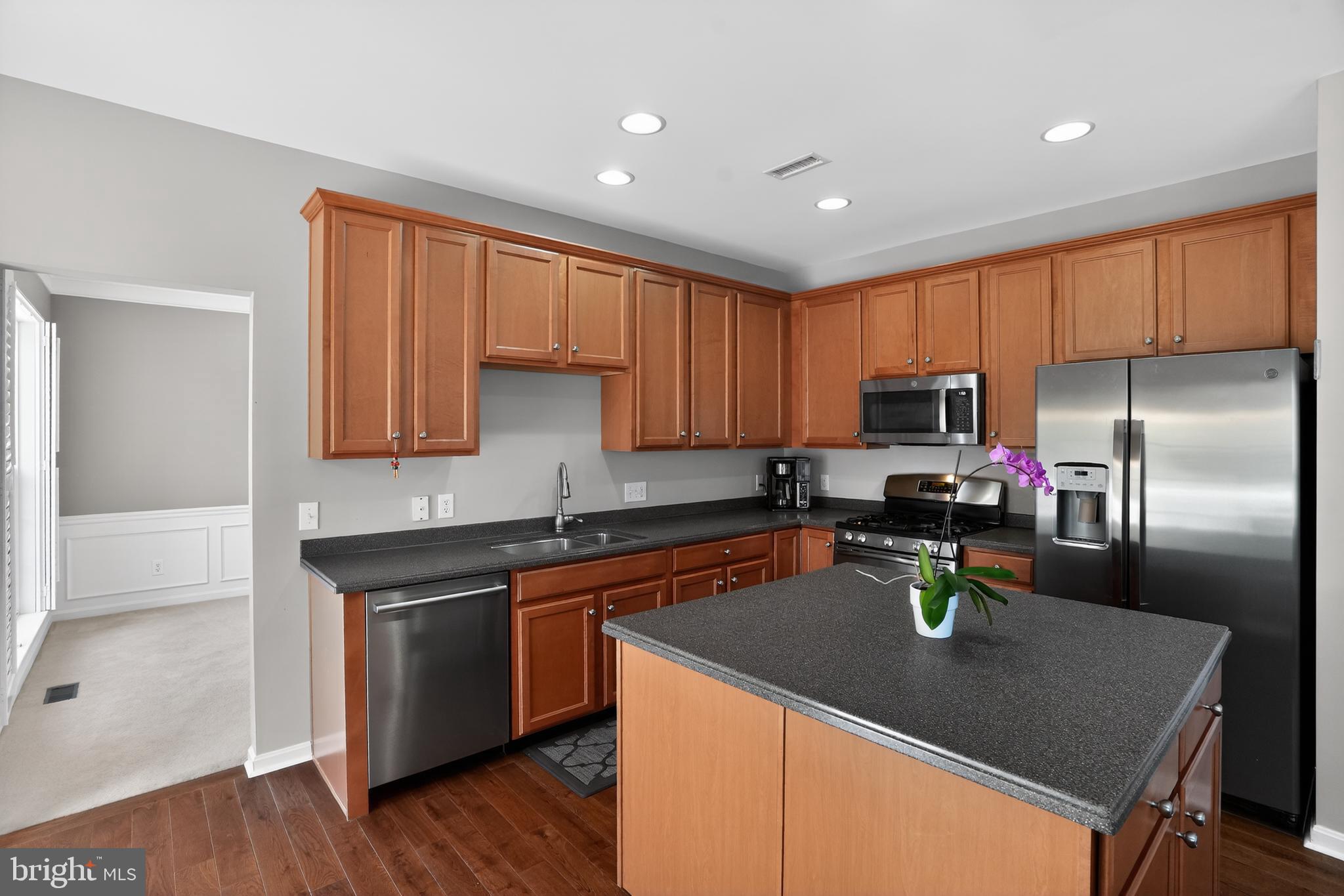694 Churchill Road Chester Springs, PA 19425 - Photo 18 of 49 a kitchen with granite countertop kitchen island stainless steel appliances a sink a stove a microwave a sink a refrigerator and cabinets