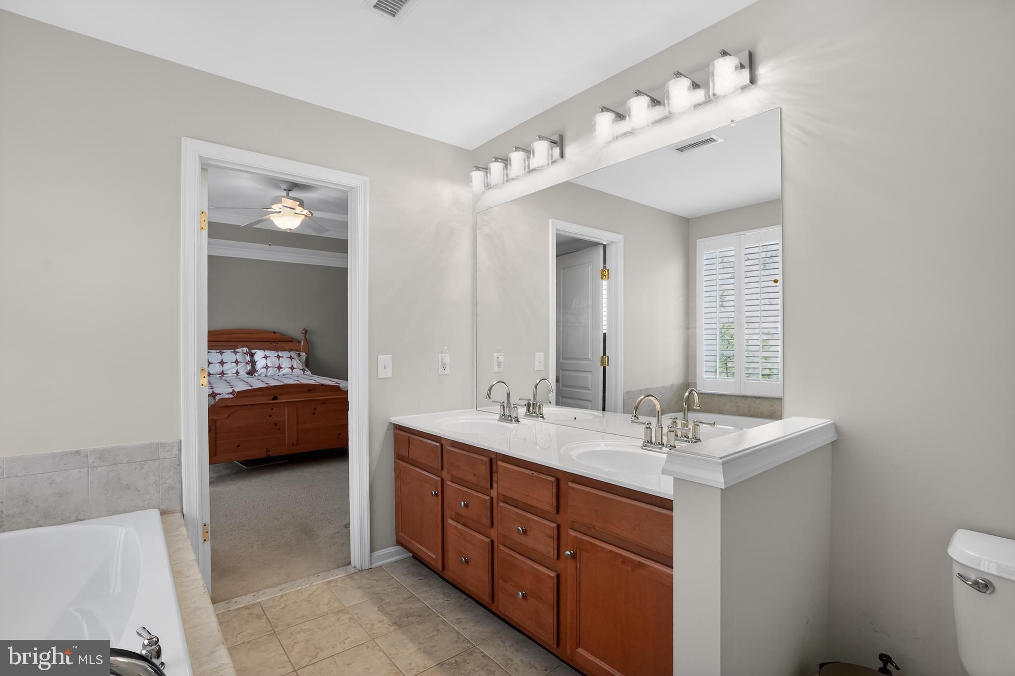 694 Churchill Road Chester Springs, PA 19425 - Photo 32 of 49 a en suite bathroom with a double vanity sink and a mirror