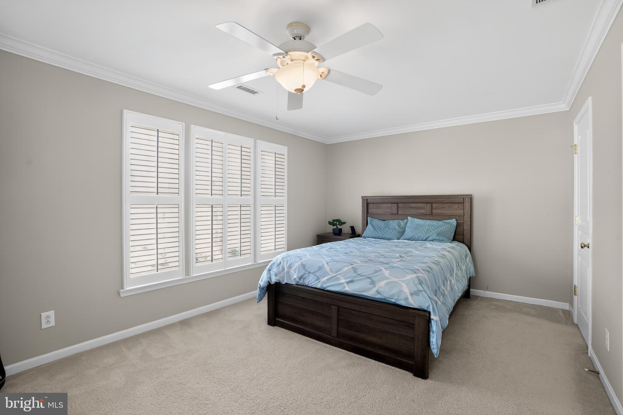 694 Churchill Road Chester Springs, PA 19425 - Photo 33 of 49 a spacious bedroom with a bed and a chandelier