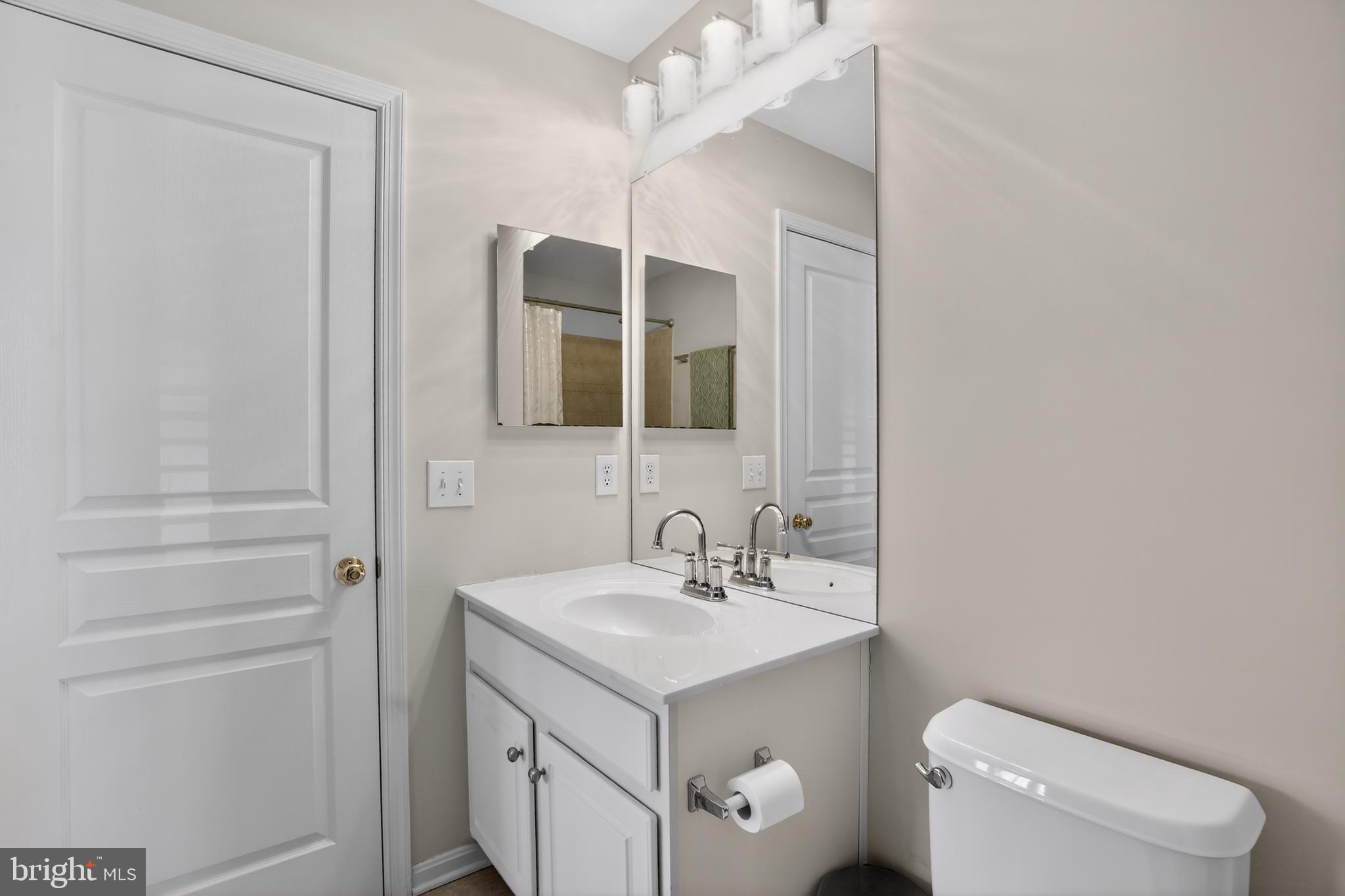 694 Churchill Road Chester Springs, PA 19425 - Photo 38 of 49 a bathroom with a sink toilet and mirror