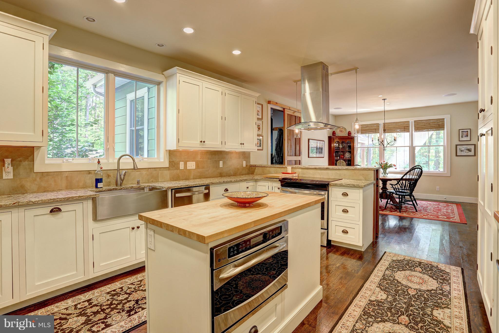 16526 Dubbs Road Sparks, MD 21152 - Photo 11 of 29 a kitchen with a stove a sink and a refrigerator
