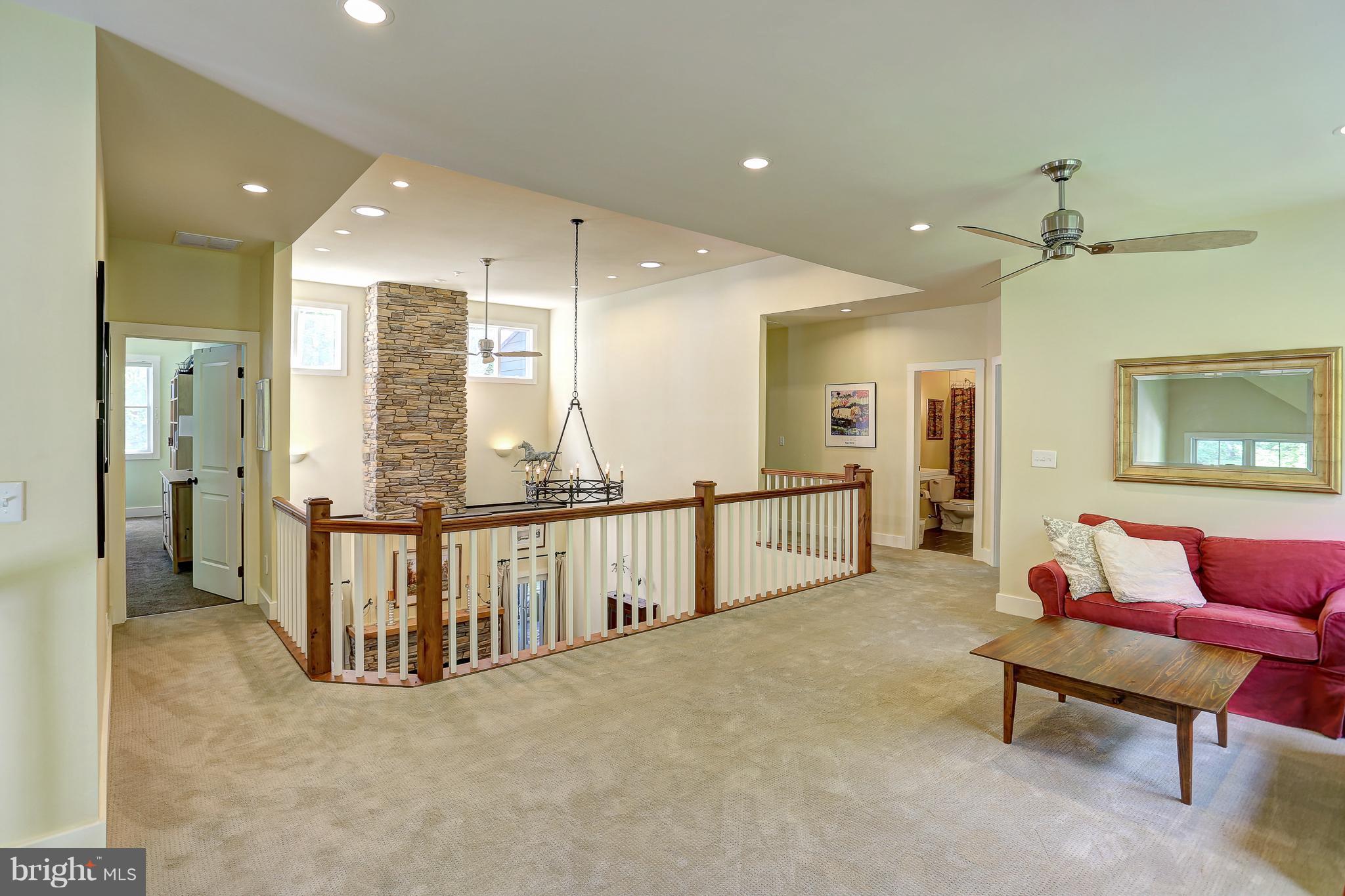 16526 Dubbs Road Sparks, MD 21152 - Photo 18 of 29 a view of a hallway with furniture and a chandelier
