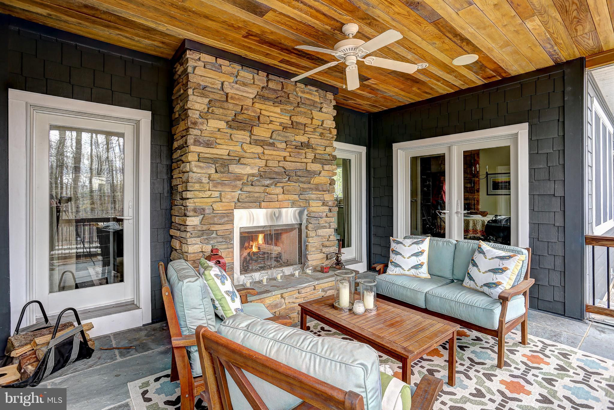 16526 Dubbs Road Sparks, MD 21152 - Photo 3 of 29 a outdoor living space with furniture and a fireplace