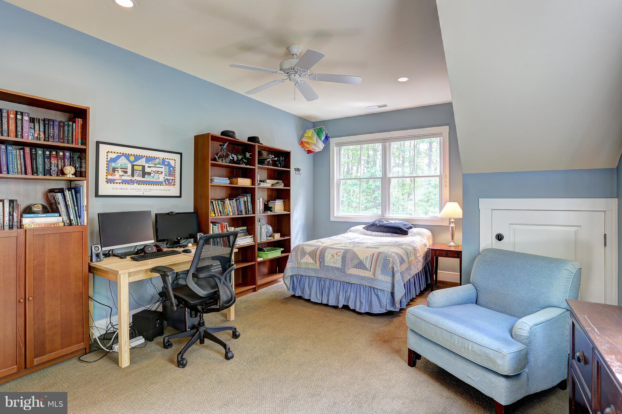 16526 Dubbs Road Sparks, MD 21152 - Photo 21 of 29 a spacious bedroom with a bed and a bookshelf