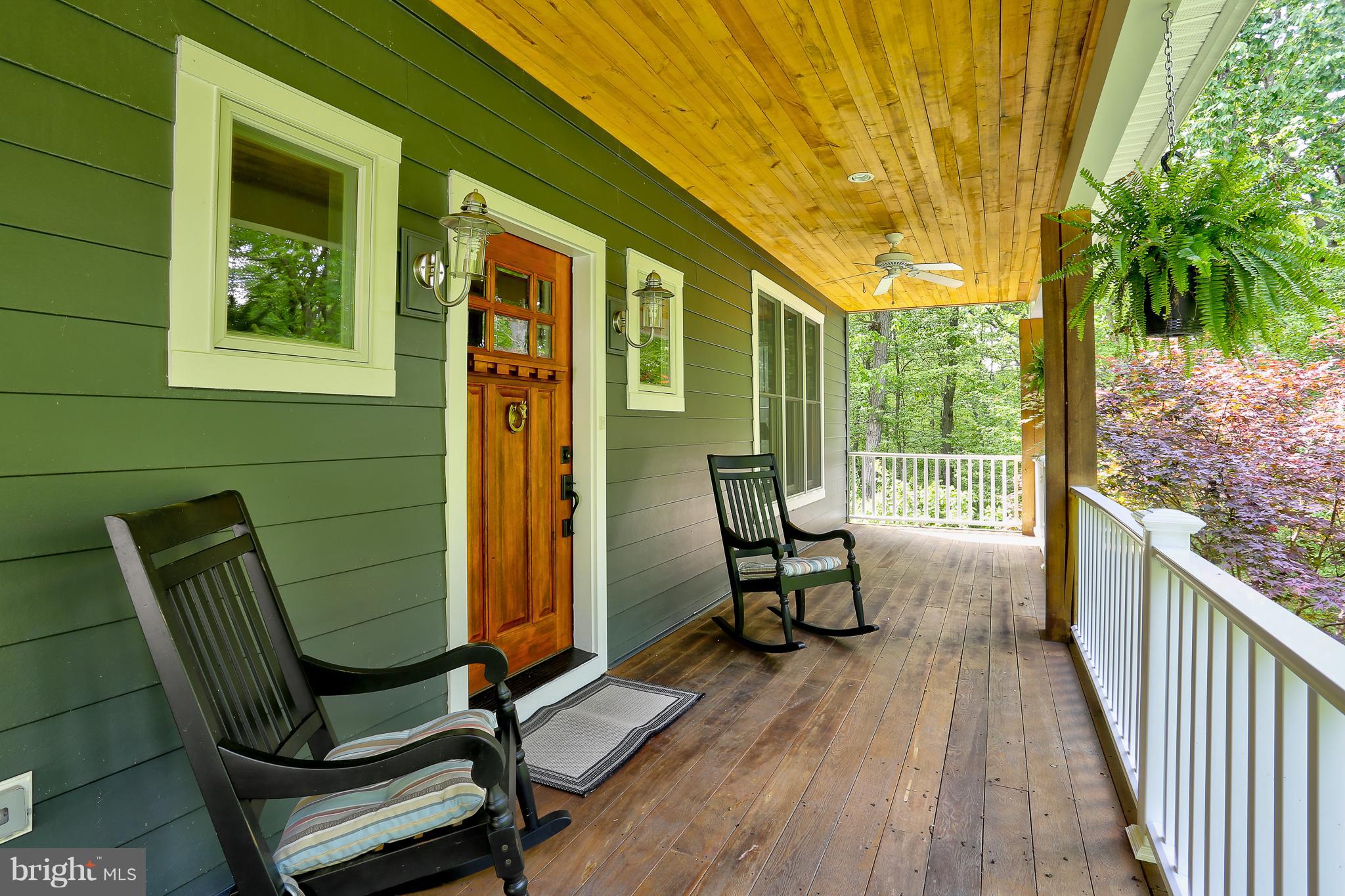 16526 Dubbs Road Sparks, MD 21152 - Photo 5 of 29 a view of a balcony with chairs and wooden fence
