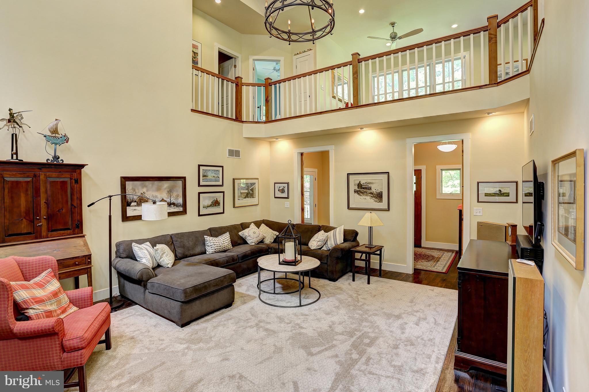 16526 Dubbs Road Sparks, MD 21152 - Photo 9 of 29 a living room with furniture and a chandelier