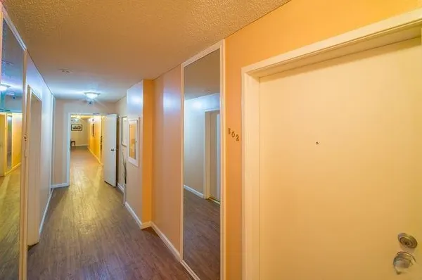 a view of hallway with wooden floor