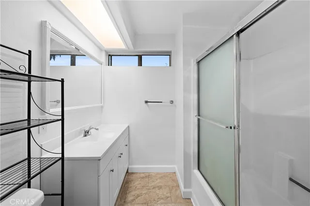 a bathroom with a double vanity sink and mirror