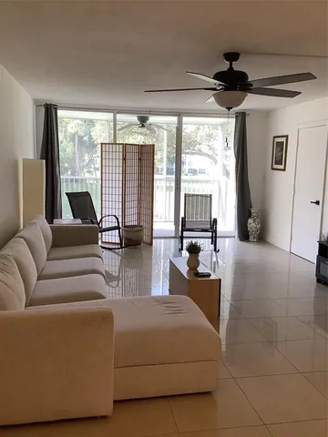 a living room with furniture and large windows