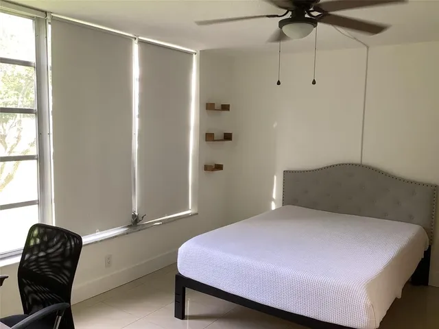 a bedroom with a bed and a chair