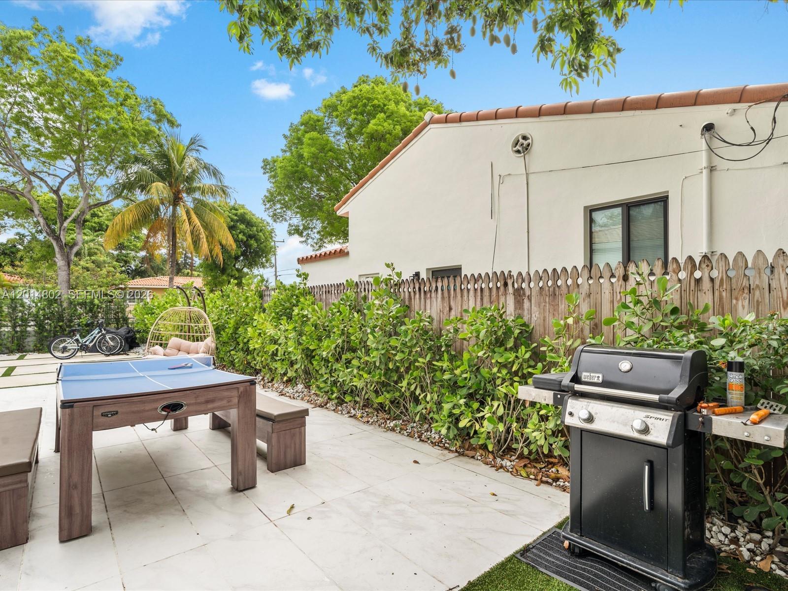 825 Southwest 23rd Road, Unit 1 Miami, FL 33129 - Photo 17 of 92 a view of a chairs and table in the back yard of a house