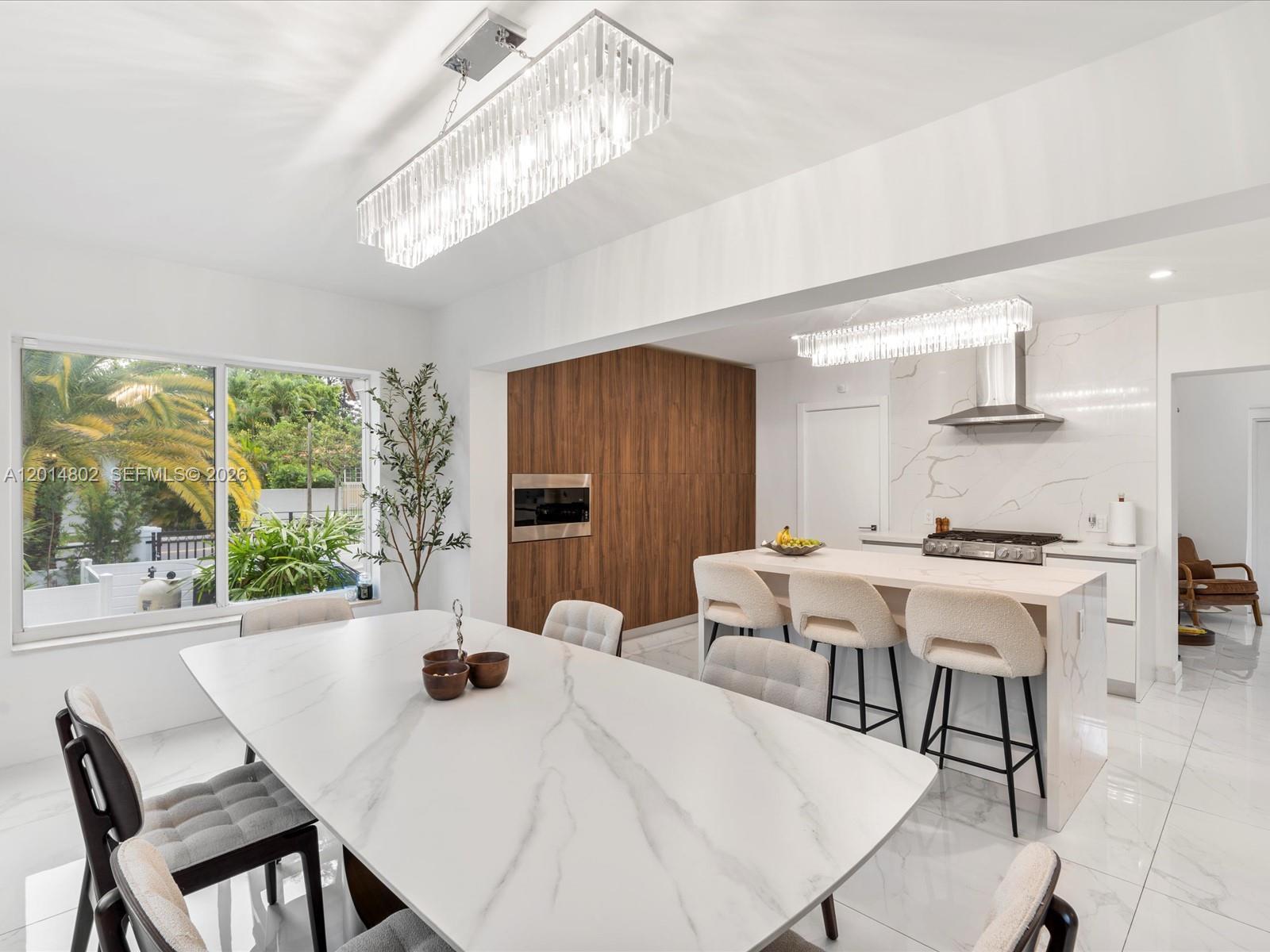 825 Southwest 23rd Road, Unit 1 Miami, FL 33129 - Photo 45 of 92 a kitchen with a table chairs and a stove