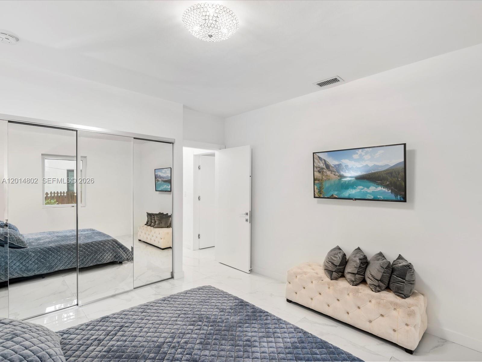 825 Southwest 23rd Road, Unit 1 Miami, FL 33129 - Photo 60 of 92 a bedroom with furniture and wooden floor