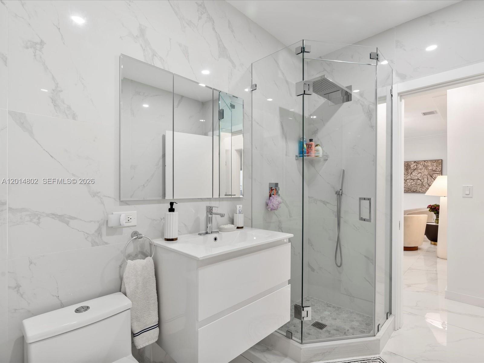 825 Southwest 23rd Road, Unit 1 Miami, FL 33129 - Photo 62 of 92 a bathroom with a shower sink and mirror