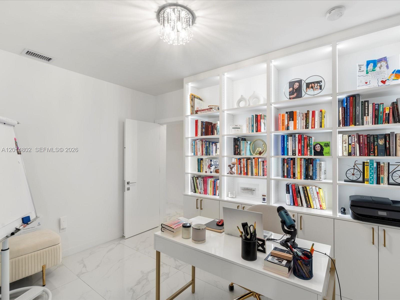 825 Southwest 23rd Road, Unit 1 Miami, FL 33129 - Photo 65 of 92 a view of a workspace with furniture and a book shelf