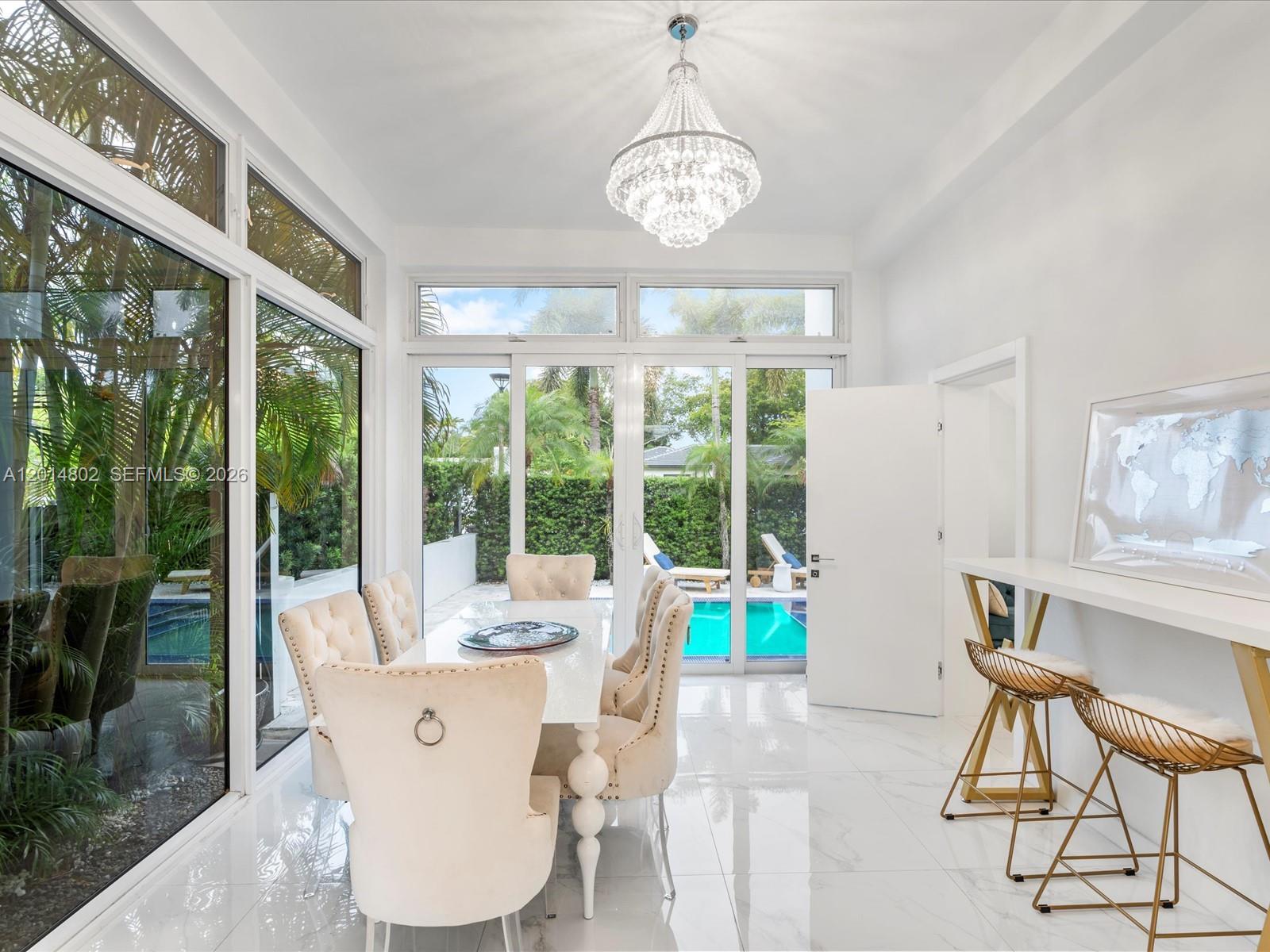 825 Southwest 23rd Road, Unit 1 Miami, FL 33129 - Photo 67 of 92 a dining room with furniture a chandelier and wooden floor