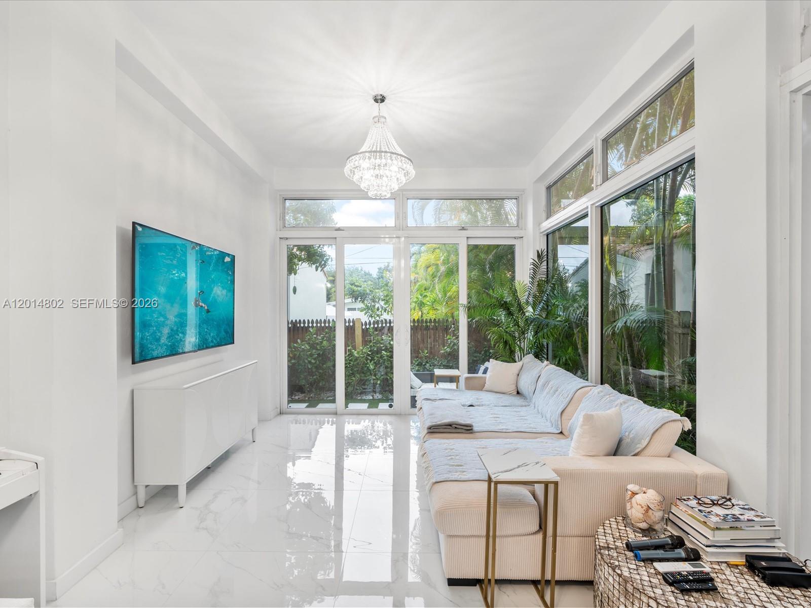 825 Southwest 23rd Road, Unit 1 Miami, FL 33129 - Photo 70 of 92 a living room with furniture tv and a large window