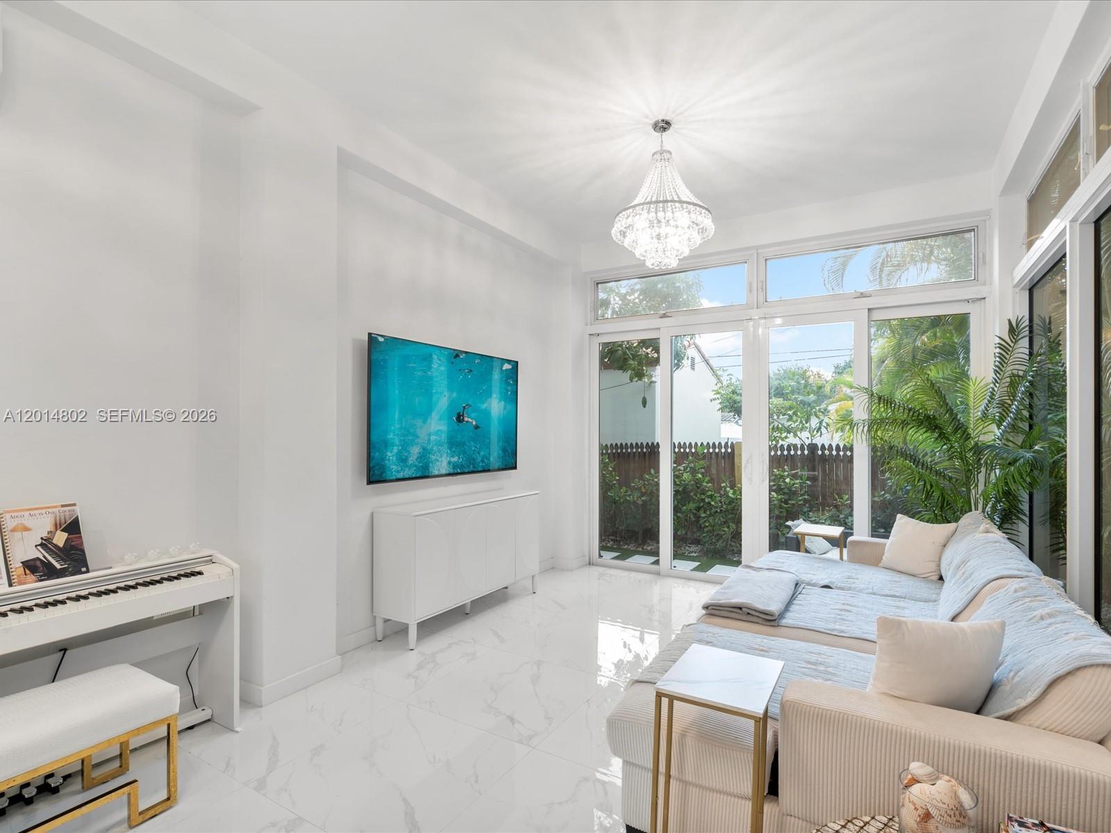 825 Southwest 23rd Road, Unit 1 Miami, FL 33129 - Photo 71 of 92 a living room with furniture a flat screen tv and a large window