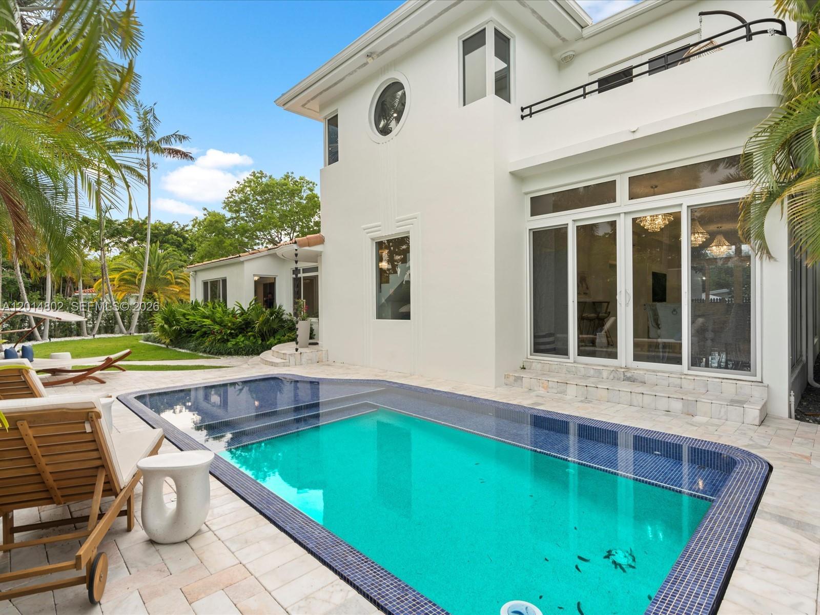 825 Southwest 23rd Road, Unit 1 Miami, FL 33129 - Photo 9 of 92 a view of an house with swimming pool and porch