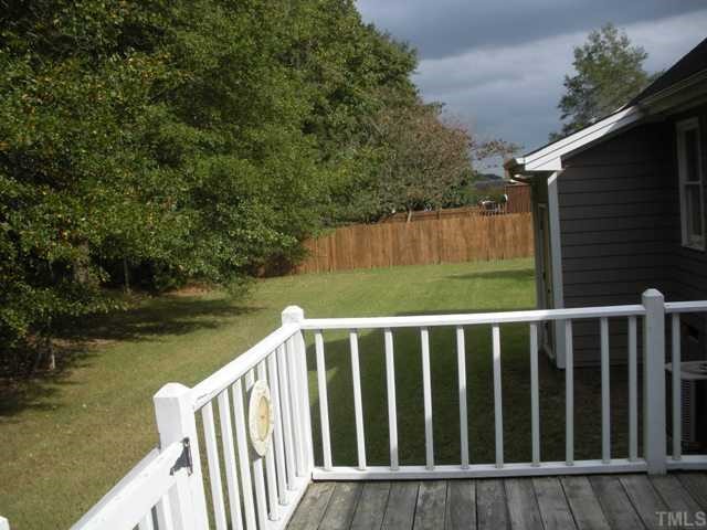 9841 Joe Leach Road Raleigh, NC 27603 - Photo 3 of 11 a view of a wooden deck and lake