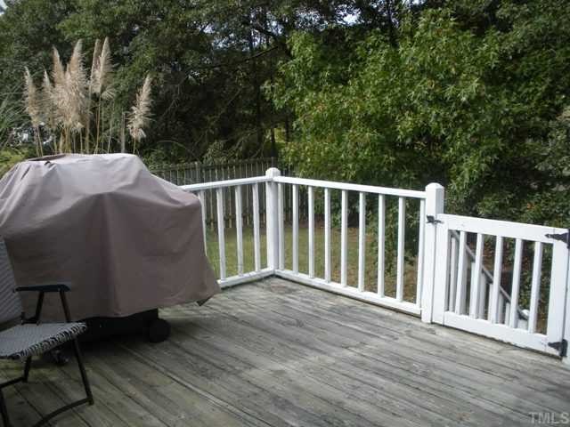 9841 Joe Leach Road Raleigh, NC 27603 - Photo 4 of 11 a balcony with wooden floor and yard in the back