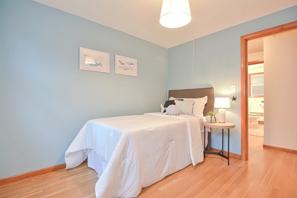 3 Smart Road Acton, MA 01720 - Photo 16 of 23 a bedroom with a bed and wooden floor