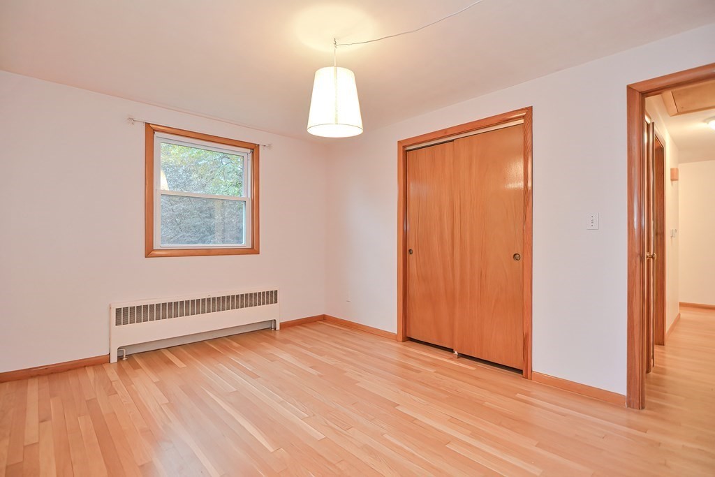 3 Smart Road Acton, MA 01720 - Photo 17 of 23 an empty room with wooden floor and windows