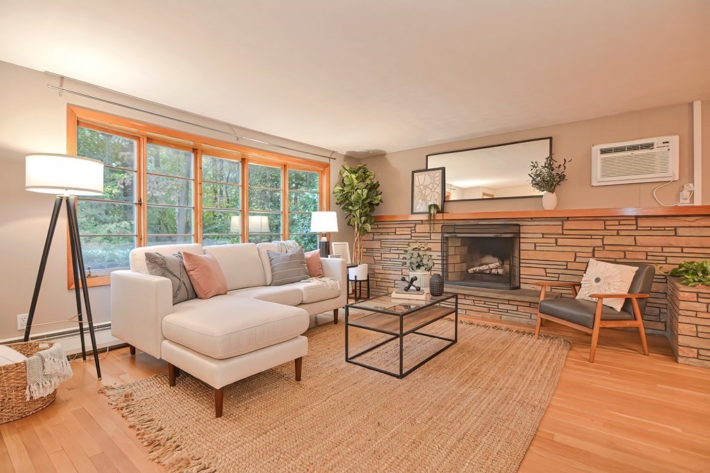 3 Smart Road Acton, MA 01720 - Photo 3 of 23 a living room with furniture and a fireplace