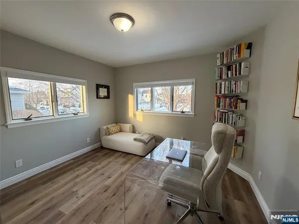 a view of a livingroom with furniture and a window