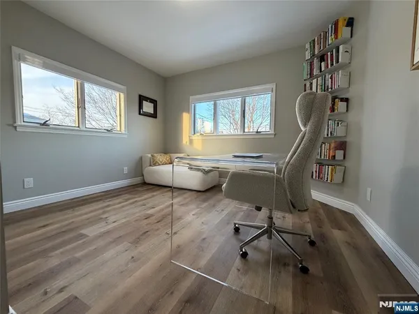 a living room with furniture a rug and a window