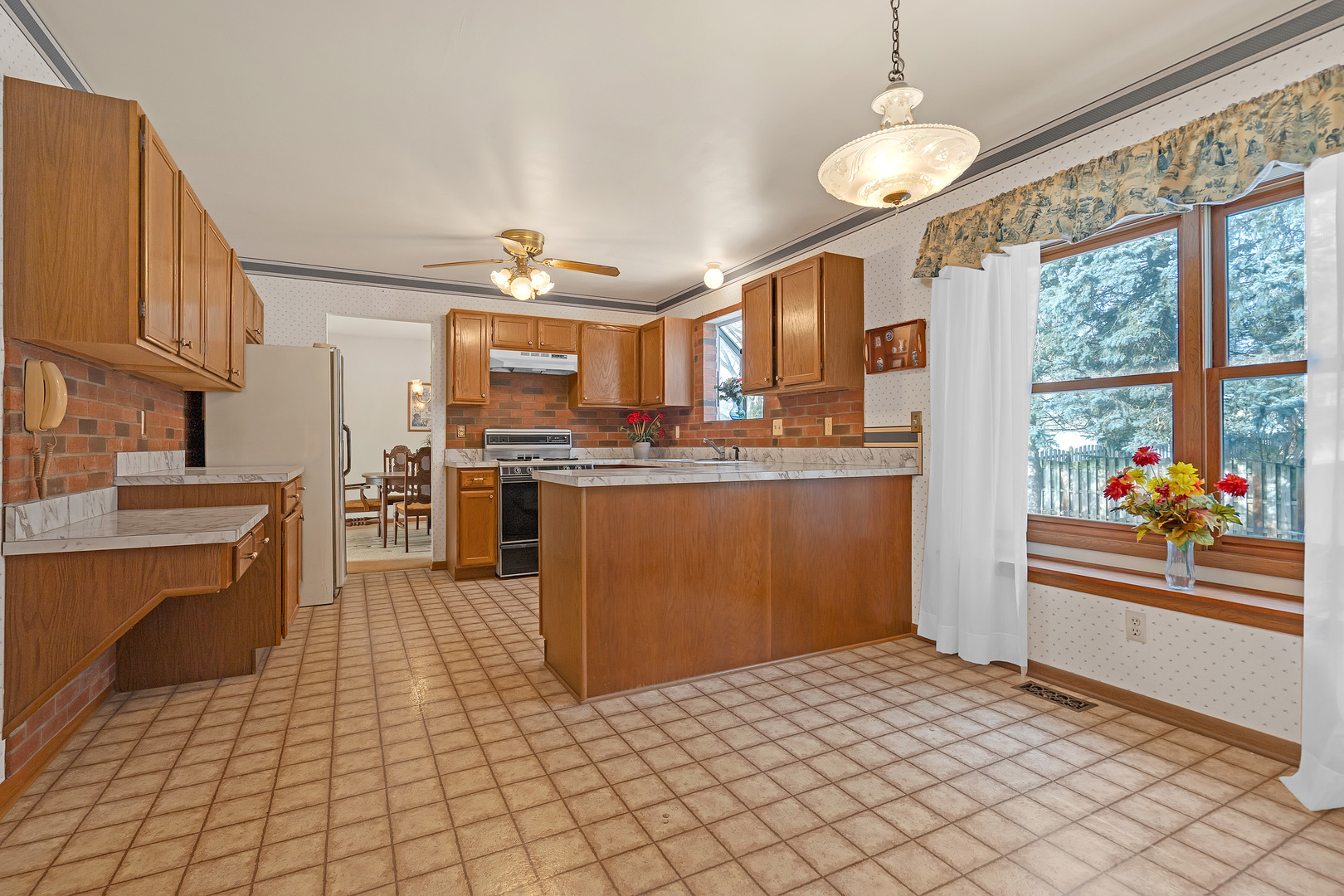 121 South Raddant Road Batavia, IL 60510 - Photo 9 of 22 a kitchen with stainless steel appliances kitchen island granite countertop a refrigerator and a stove top oven
