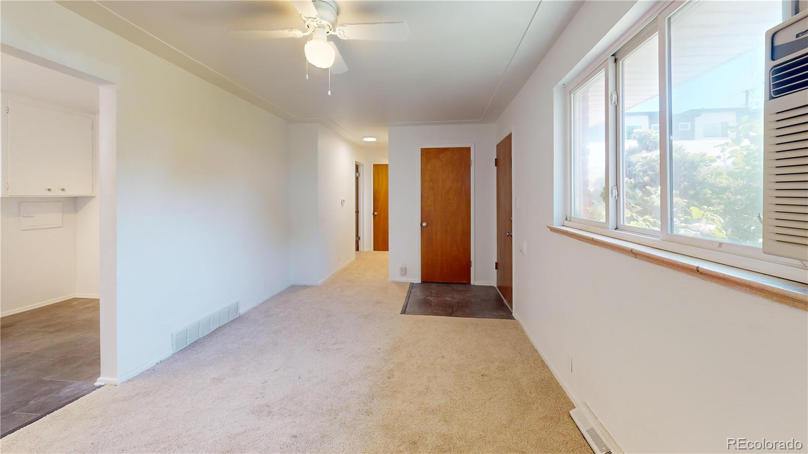 7805 West 41st Avenue, Unit 4 Wheat Ridge, CO 80033 - Photo 3 of 17 an empty room with windows and closet