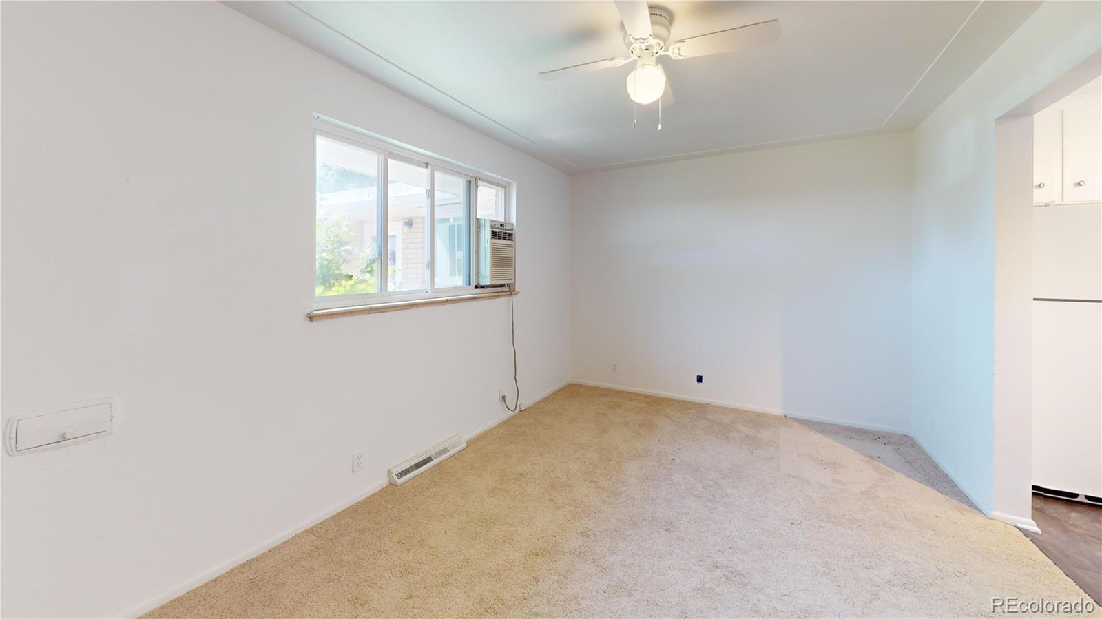 7805 West 41st Avenue, Unit 4 Wheat Ridge, CO 80033 - Photo 4 of 17 an empty room with a window