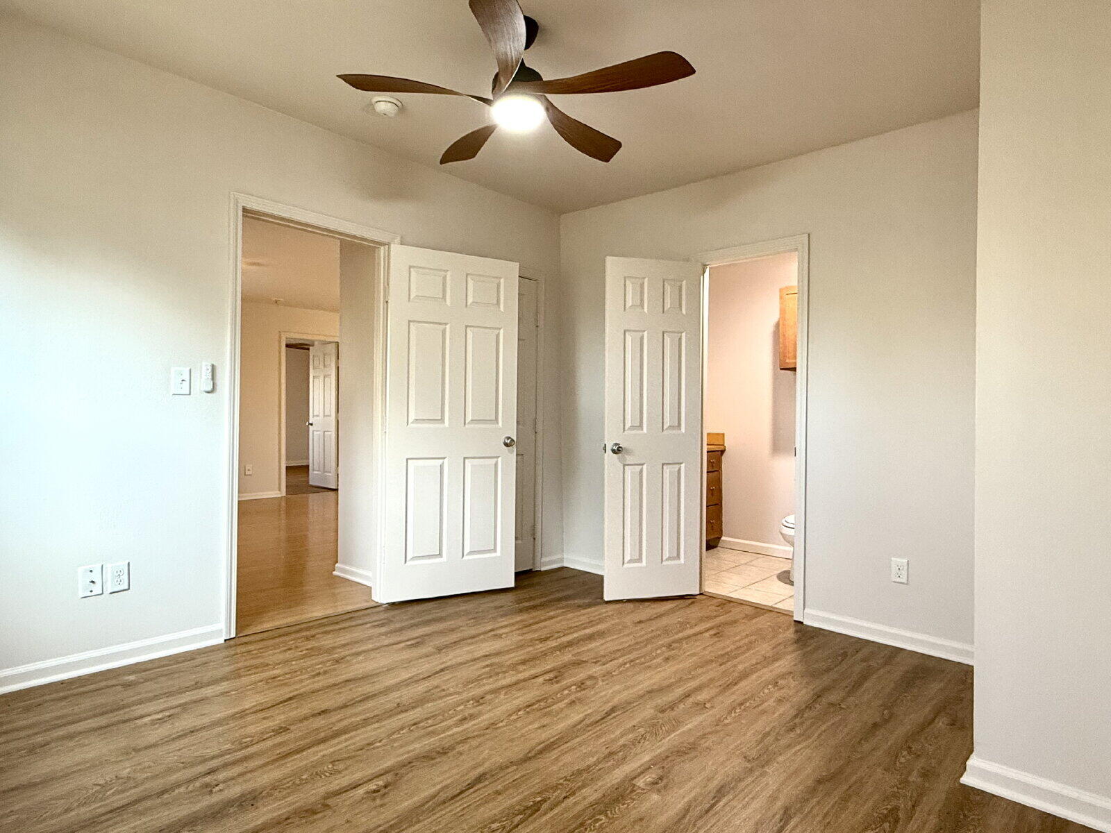3118 37th Street, Unit B Lubbock, TX 79413 - Photo 15 of 21 a view of empty room with wooden floor and fan