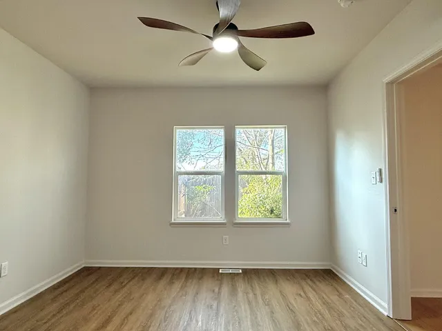wooden floor in an empty room with a window