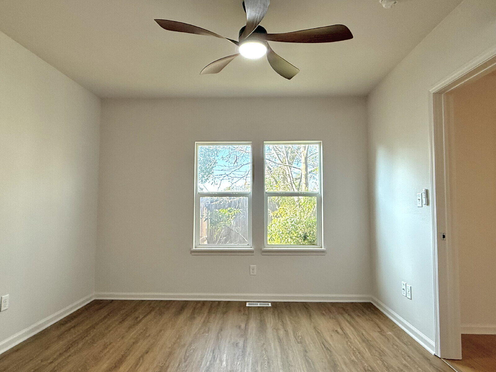 3118 37th Street, Unit B Lubbock, TX 79413 - Photo 16 of 21 wooden floor in an empty room with a window