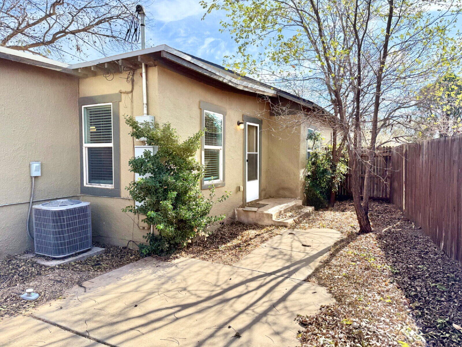 3118 37th Street, Unit B Lubbock, TX 79413 - Photo 20 of 21 a front view of a house with potted plants