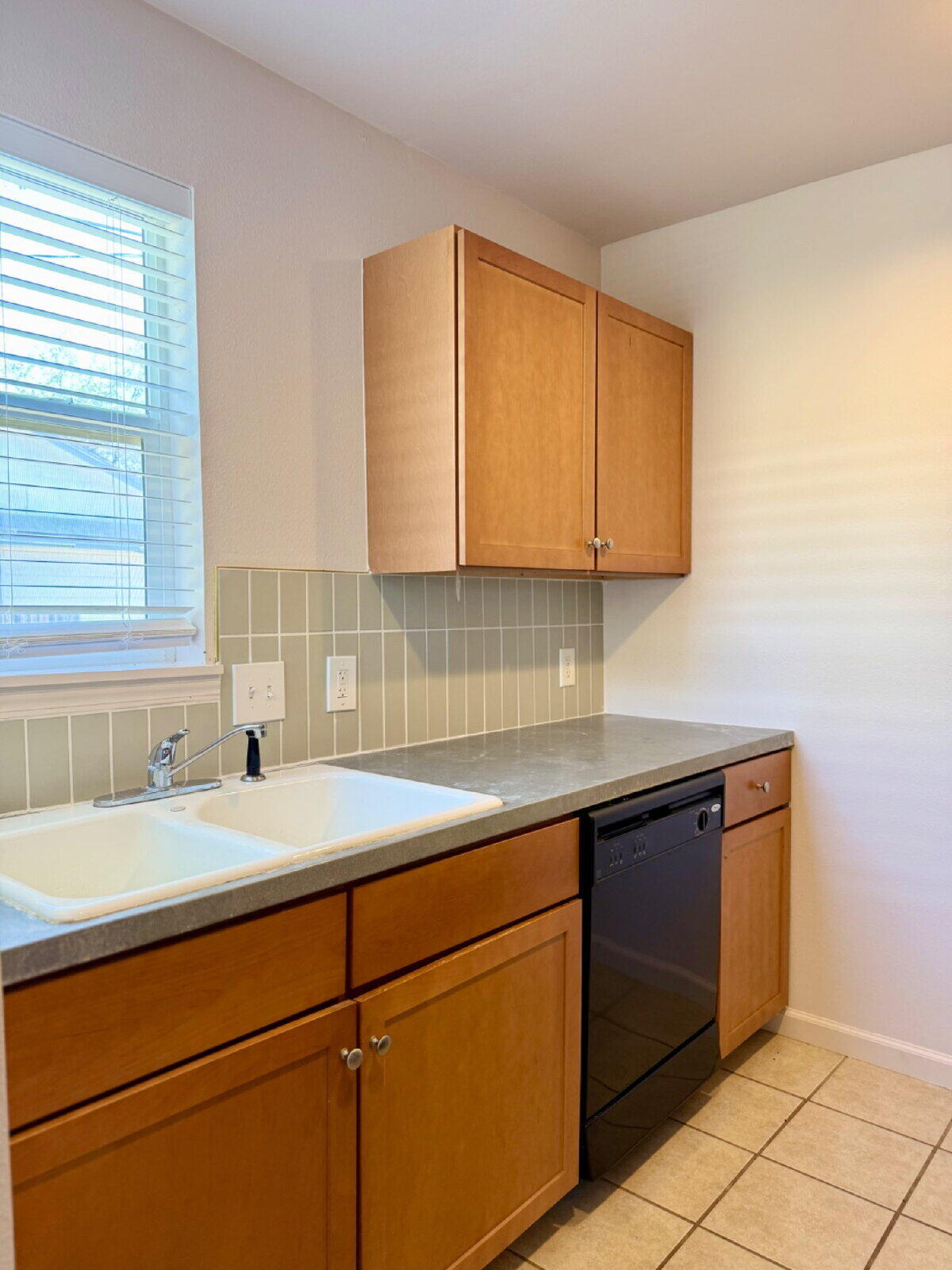 3118 37th Street, Unit B Lubbock, TX 79413 - Photo 7 of 21 a kitchen with a sink cabinets and a window