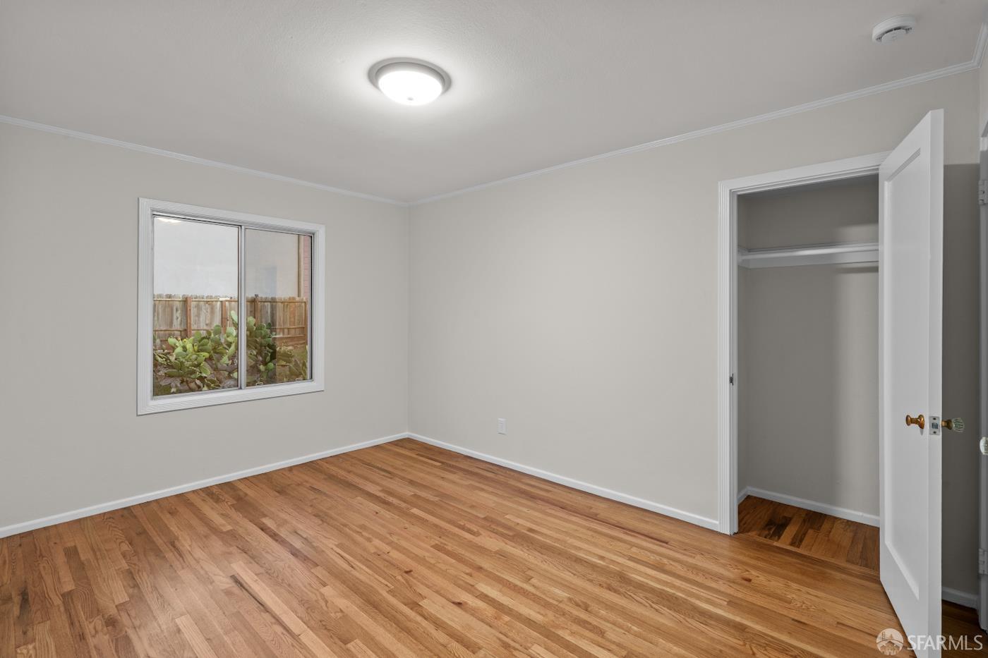 193 Hillside Boulevard Daly City, CA 94014 - Photo 11 of 20 a view of an empty room with wooden floor and a window