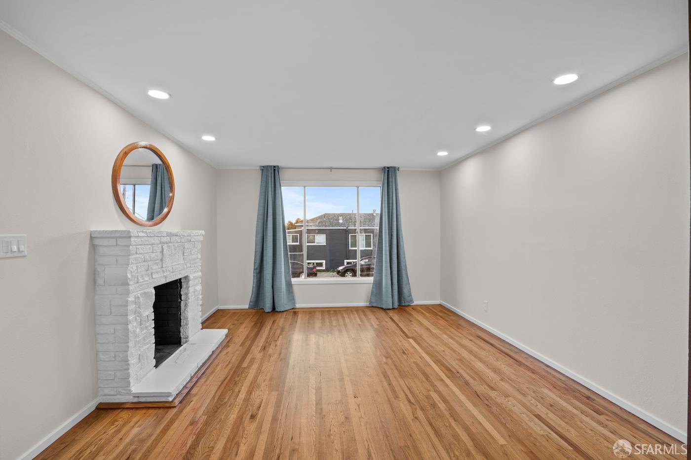 193 Hillside Boulevard Daly City, CA 94014 - Photo 3 of 20 a view of livingroom with fireplace wooden floor and window