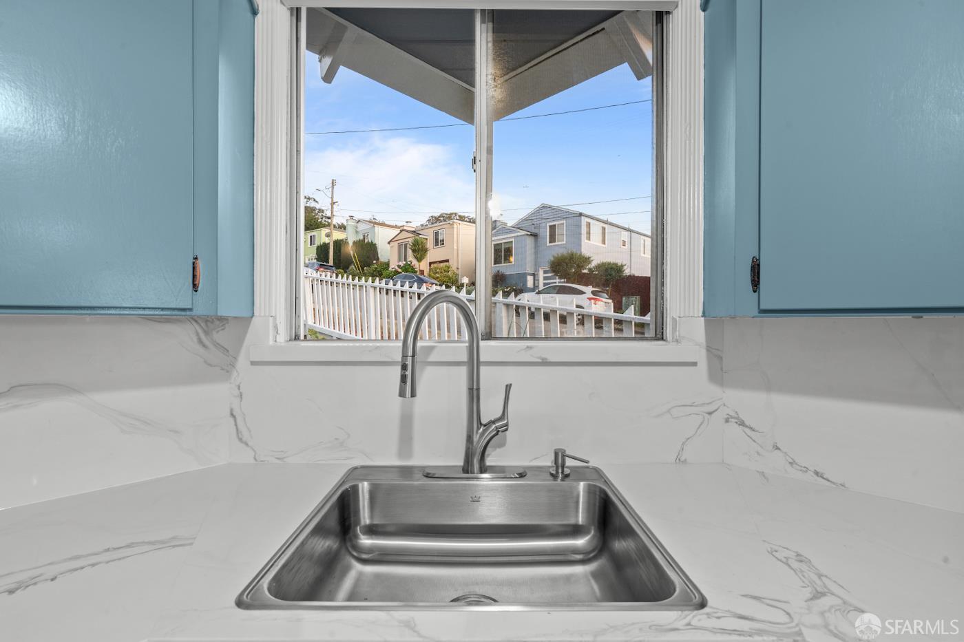 193 Hillside Boulevard Daly City, CA 94014 - Photo 8 of 20 a kitchen with a sink and a mirror