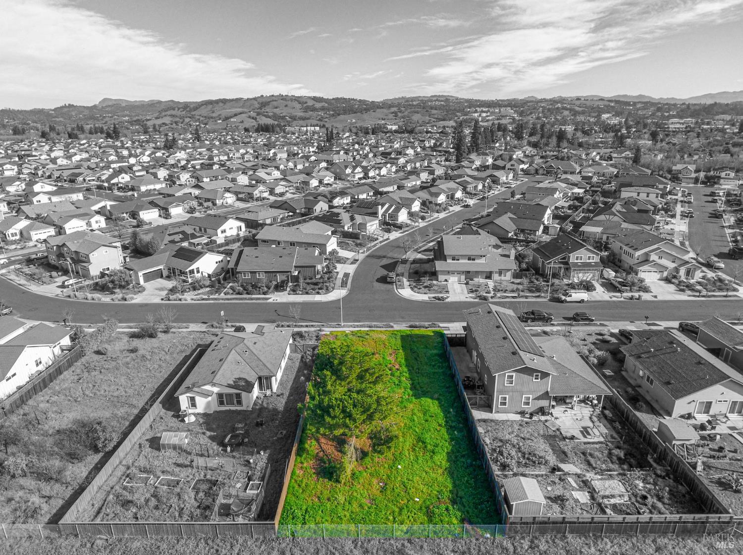 an aerial view of residential houses with outdoor space