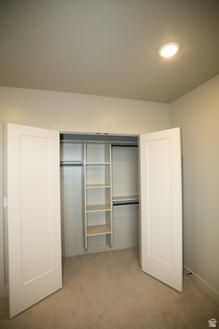 635 East Mountain Road North Ogden, UT 84414 - Photo 12 of 33 Closet with bi-fold doors, built-in shelving, two clothing rods, and recessed lighting