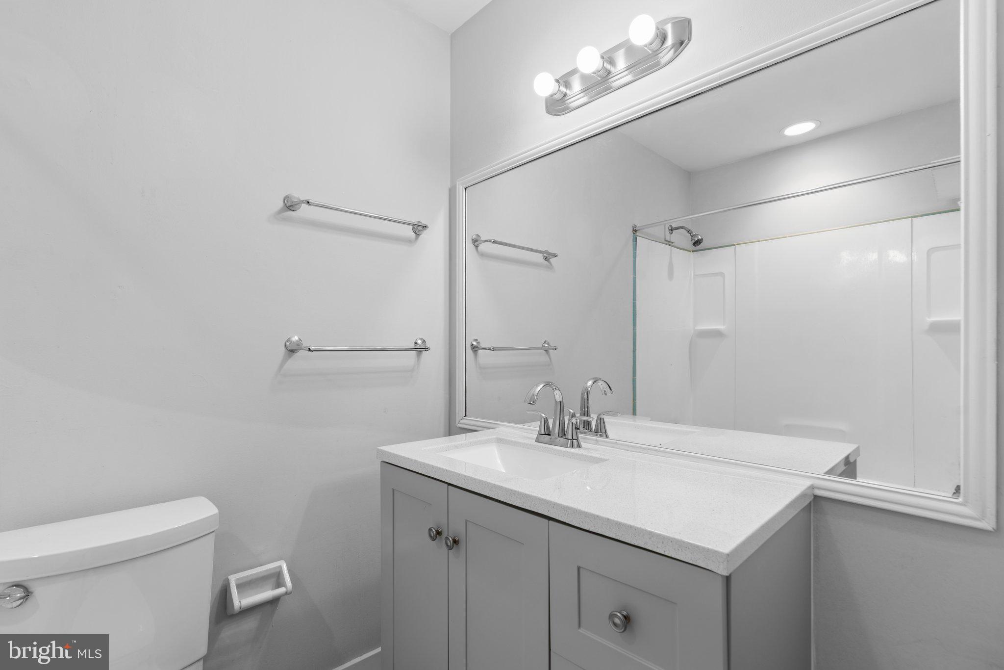 8583 Seasons Way Lanham, MD 20706 - Photo 17 of 25 a bathroom with a sink vanity and a toilet