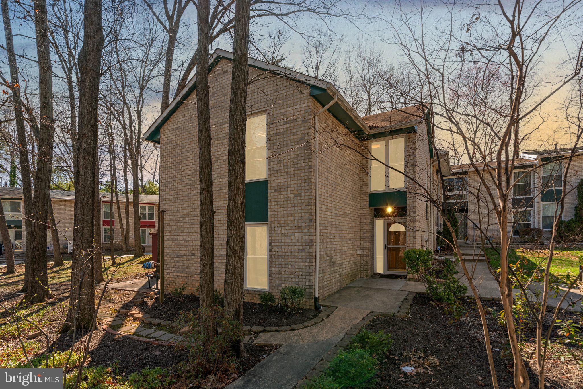 8583 Seasons Way Lanham, MD 20706 - Photo 2 of 25 a backyard of a house with lots of green space