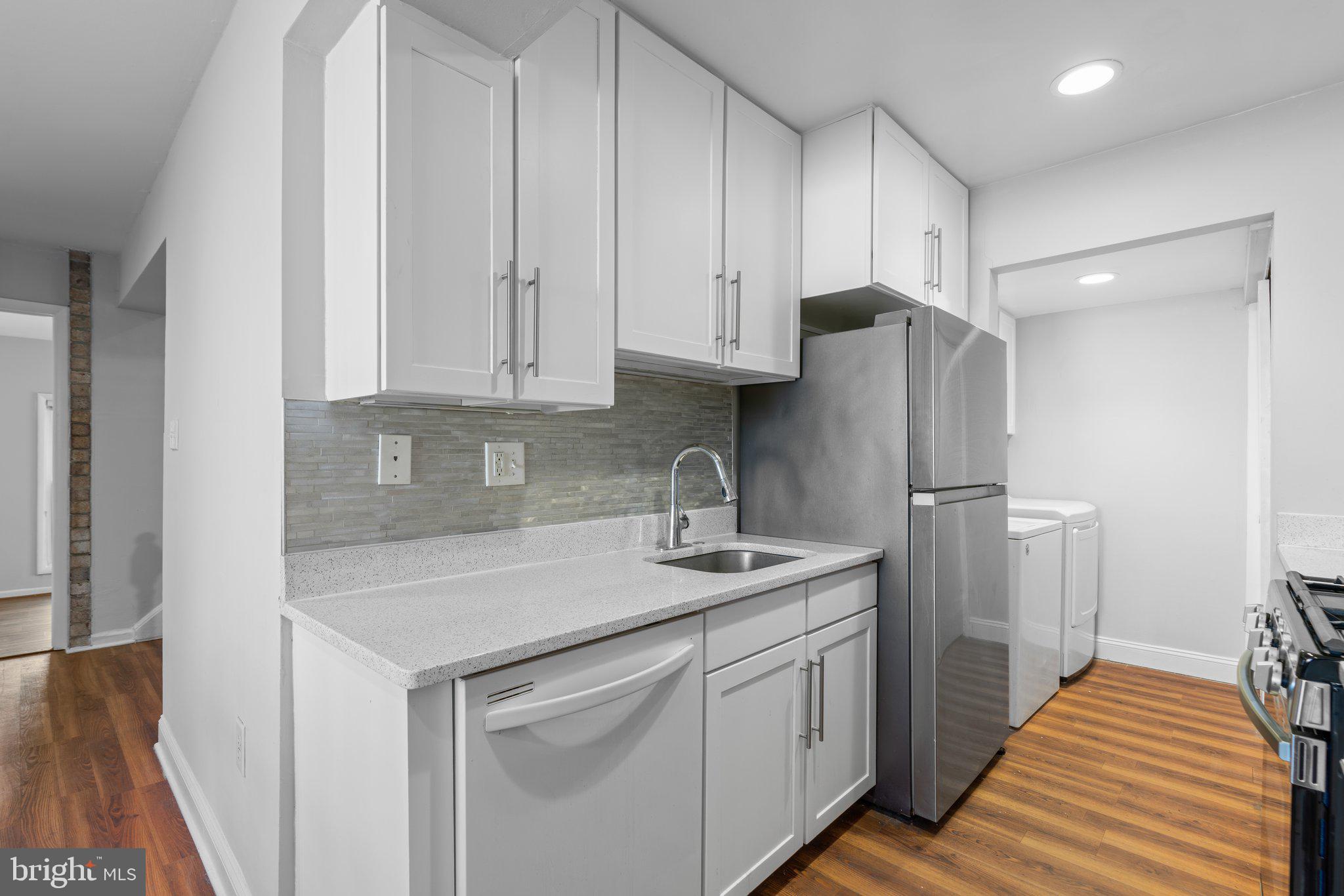 8583 Seasons Way Lanham, MD 20706 - Photo 7 of 25 a kitchen with stainless steel appliances granite countertop a refrigerator sink and cabinets