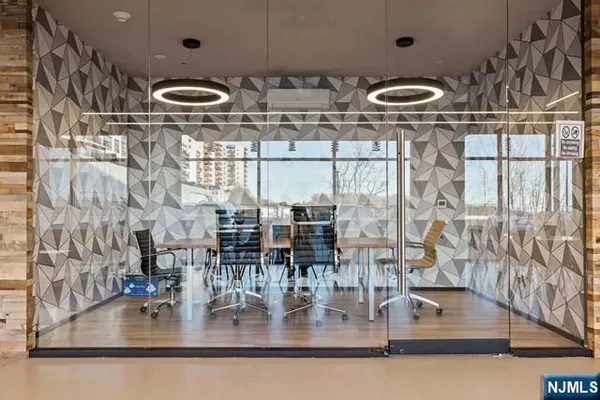 a kitchen with a sink and a stove with wooden floor