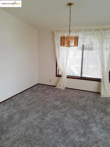 a view of a room with wooden floor and window